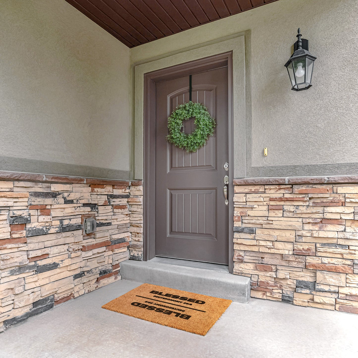 tan outdoor doormat at front door with wreath